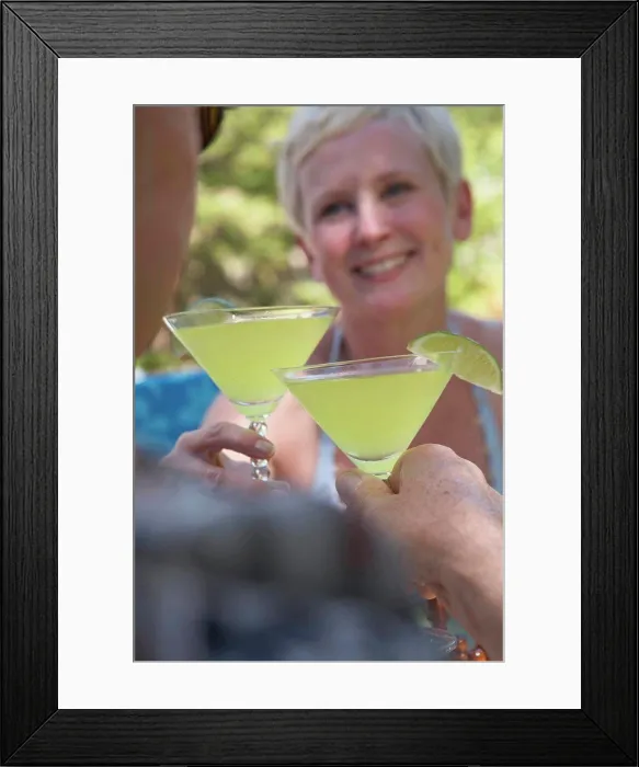 Framed Print : Close-up of a mature couple toasting with martini glasses Framed Print : Close-up of a mature couple toasting with martini glasses