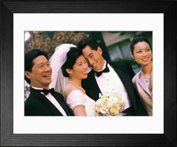 Framed Print : Newlywed couple smiling with their parents Framed Print : Newlywed couple smiling with their parents