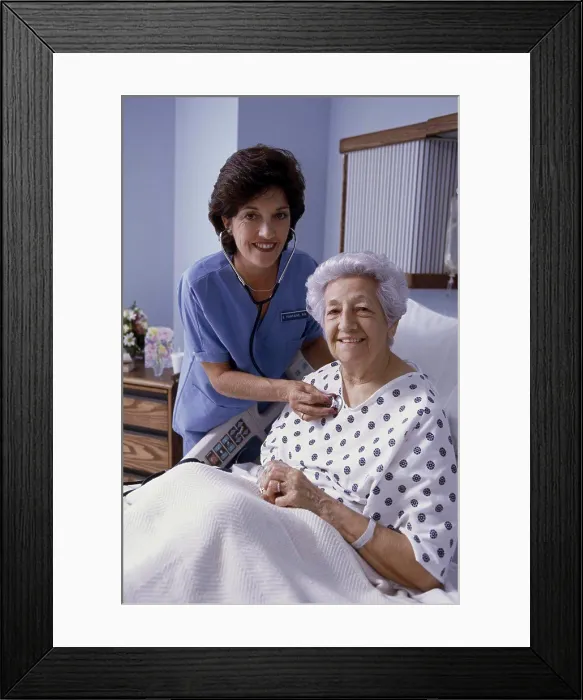 Framed Print : Portrait of a female nurse examining a patient Framed Print : Portrait of a female nurse examining a patient