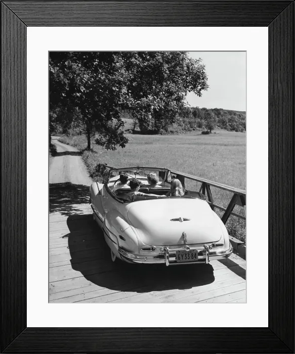 Framed Print : Family traveling in convertible car