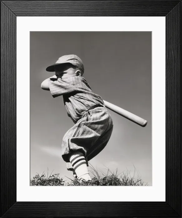 Framed Print : Side profile of a boy swinging a baseball bat