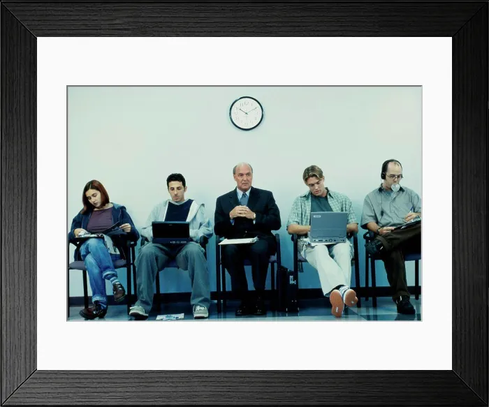Framed Print : Business executives sitting in a row operating laptops Framed Print : Business executives sitting in a row operating laptops