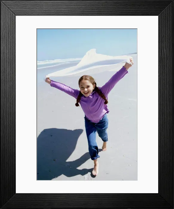 Framed Print : Portrait of a girl running on the beach Framed Print : Portrait of a girl running on the beach