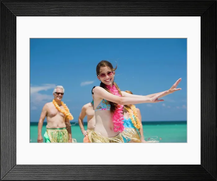 Framed Print : Close-up of a girl hula dancing on the beach with her grandparents and father standing in the background Framed Print : Close-up of a girl hula dancing on the beach with her grandparents and father standing in the background