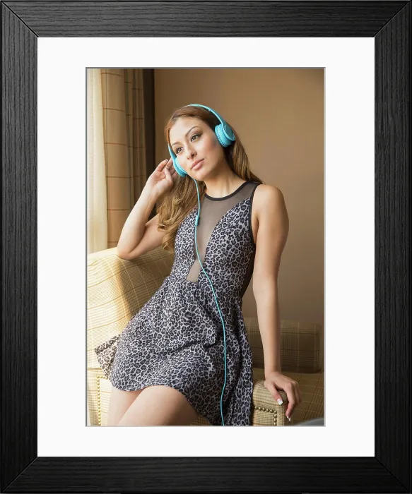 Framed Print : Teenager wearing dress listening to headphones Framed Print : Teenager wearing dress listening to headphones