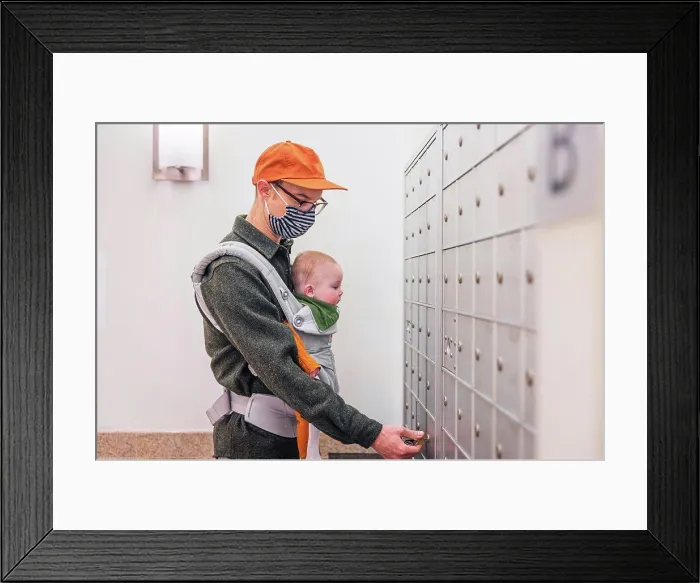 Framed Print : Father wearing face mask opening locker in room while carrying baby girl during COVID-19 crisis Framed Print : Father wearing face mask opening locker in room while carrying baby girl during COVID-19 crisis