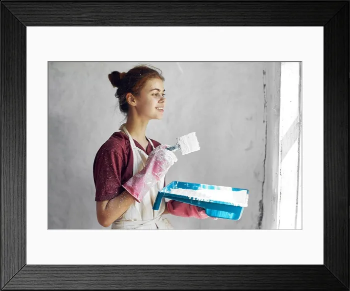 Framed Print : woman with brush in hands paint inside home interior renovation