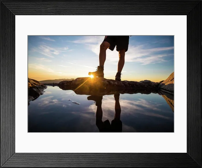 Framed Print : Lower half view of hiker wearing boots on mountain summit Framed Print : Lower half view of hiker wearing boots on mountain summit