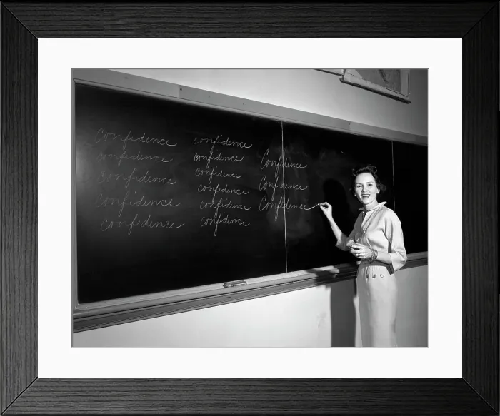 Framed Print : 1950S Teacher In Front Of Classroom Writing Confidence On Blackboard Framed Print : 1950S Teacher In Front Of Classroom Writing Confidence On Blackboard