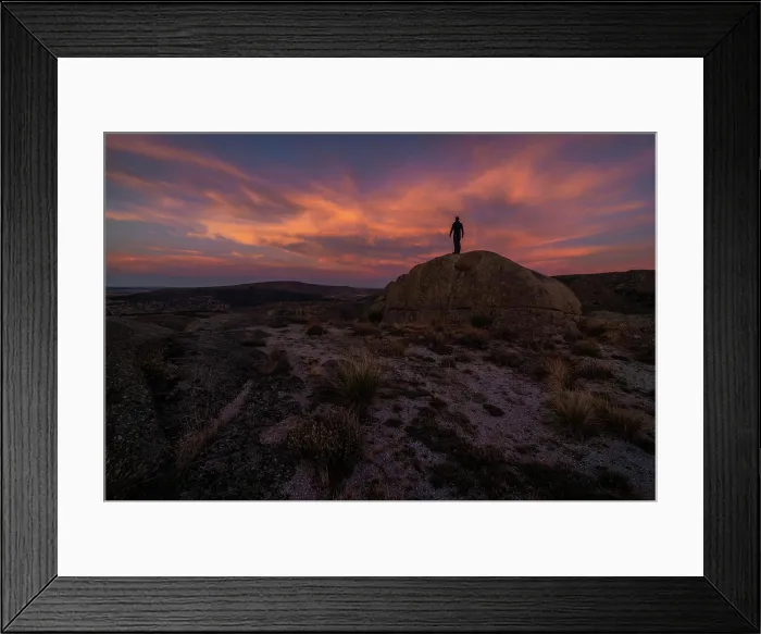 Framed Print : Silhouette of unrecognizable explorer standing on boulder against cloudy sundown sky during trip in mountainous terrain Framed Print : Silhouette of unrecognizable explorer standing on boulder against cloudy sundown sky during trip in mountainous terrain