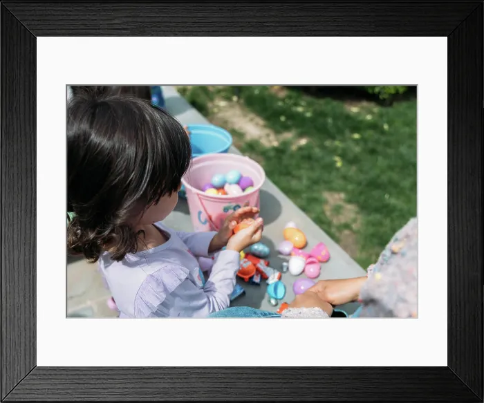 Framed Print : Young girl holding candy from an Easter Egg Hunt Framed Print : Young girl holding candy from an Easter Egg Hunt