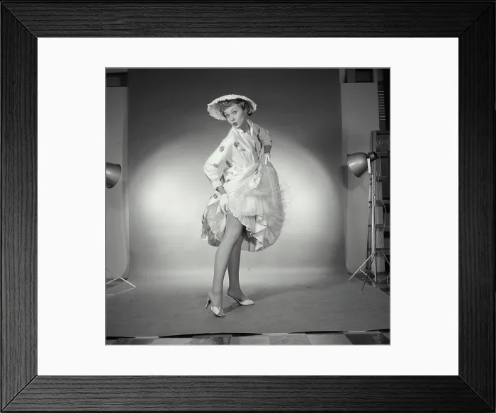 Framed Print : Portrait of young woman lifting up her evening gown Framed Print : Portrait of young woman lifting up her evening gown