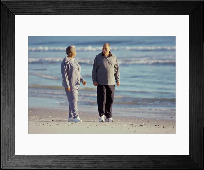 Framed Print : Senior couple standing on the beach Framed Print : Senior couple standing on the beach