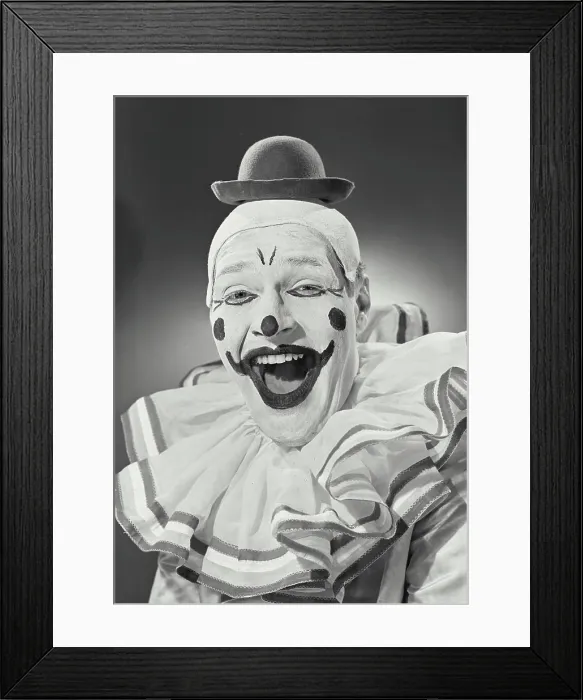 Framed Print : Vintage photograph. Portrait of clown wearing silly hat and smiling Framed Print : Vintage photograph. Portrait of clown wearing silly hat and smiling