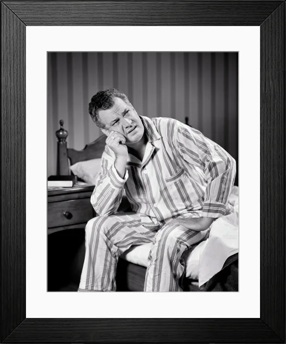 Framed Print : 1940s SLEEPLESS MATURE MAN WEARING STRIPED PAJAMAS SITTING ON EDGE OF BED WITH FRUSTRATED TIRED FACIAL EXPRESSION Framed Print : 1940s SLEEPLESS MATURE MAN WEARING STRIPED PAJAMAS SITTING ON EDGE OF BED WITH FRUSTRATED TIRED FACIAL EXPRESSION