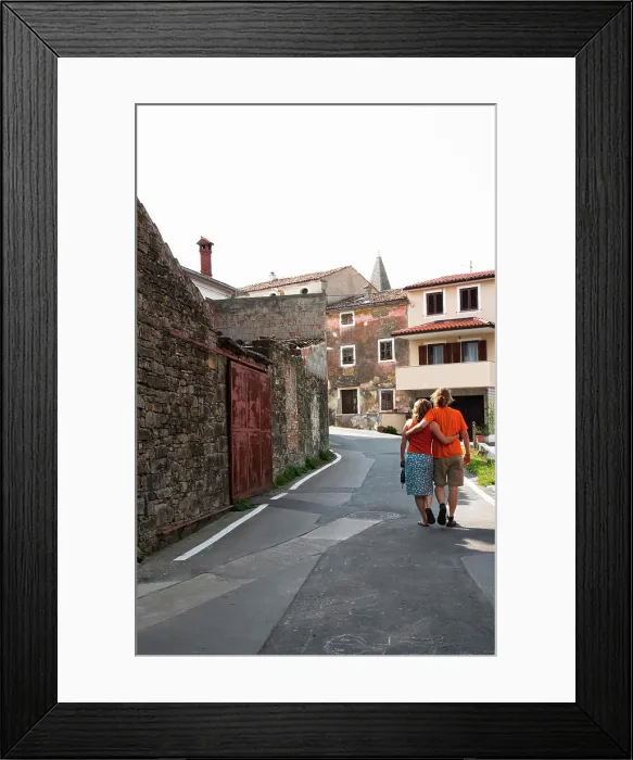 Framed Print : Slovenia - Rear view of a young couple strolling down a walkway in an Old World village. (MR) Framed Print : Slovenia - Rear view of a young couple strolling down a walkway in an Old World village. (MR)