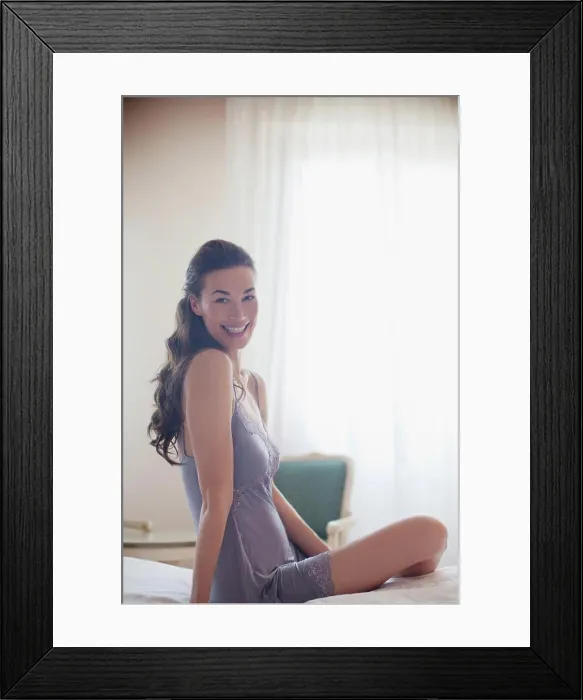 Framed Print : Venice, Portrait of smiling woman in nightgown on bed Framed Print : Venice, Portrait of smiling woman in nightgown on bed