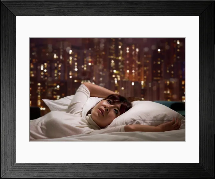 Framed Print : Woman laying on bed Framed Print : Woman laying on bed