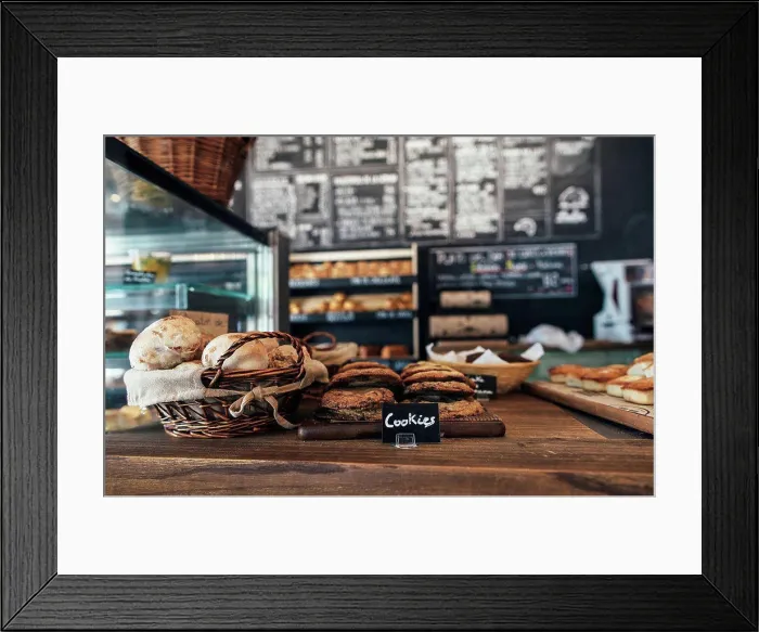 Framed Print : Fresh assortment of cookies and breads on table in bakery Framed Print : Fresh assortment of cookies and breads on table in bakery