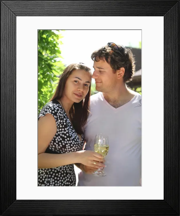 Framed Print : Happy woman and man holding glasses of white wine making a toast Framed Print : Happy woman and man holding glasses of white wine making a toast