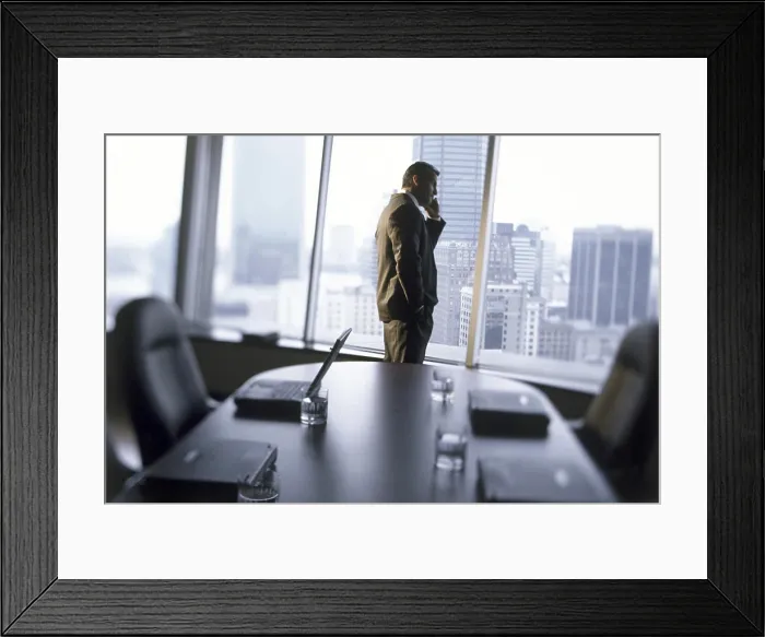 Framed Print : Side profile of a businessman talking on a mobile phone Framed Print : Side profile of a businessman talking on a mobile phone