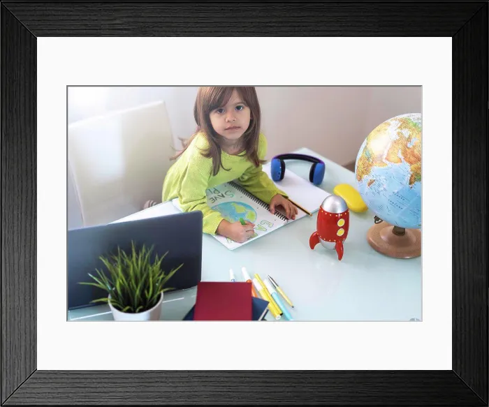 Framed Print : Smiling child girl draws planet earth with wax colors on school notebook for Earth day - Little activist girl writes Framed Print : Smiling child girl draws planet earth with wax colors on school notebook for Earth day - Little activist girl writes