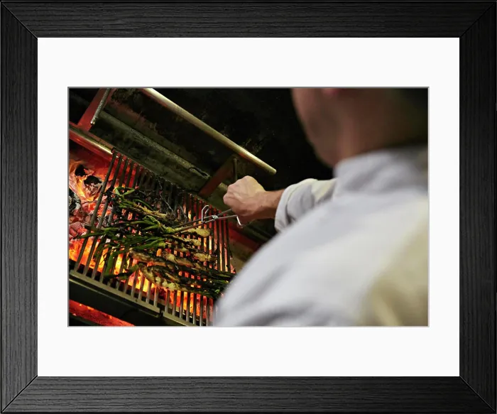 Framed Print : Chef turning Catalan Calçots cooking on charcoals Framed Print : Chef turning Catalan Calçots cooking on charcoals