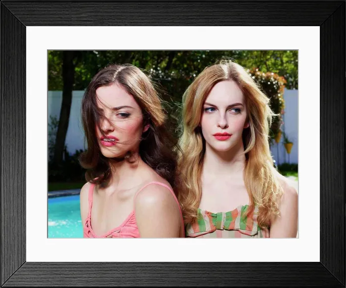 Framed Print : Closeup portrait of two women in vintage style bathing suits, sitting outside by a pool