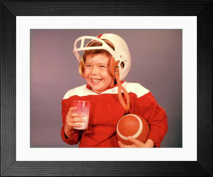 Framed Print : 1960S Boy Drinking Milk Wearing Football Helmet Red Jersey Holding Ball Framed Print : 1960S Boy Drinking Milk Wearing Football Helmet Red Jersey Holding Ball