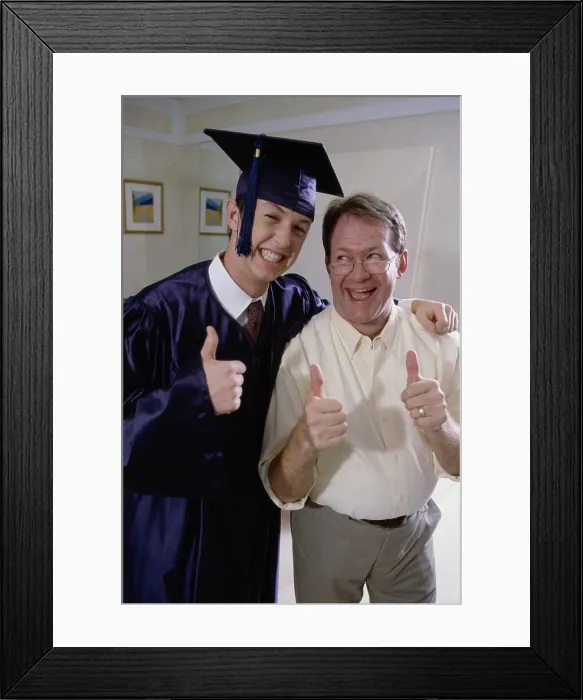 Framed Print : Portrait of a young male graduate standing with his father