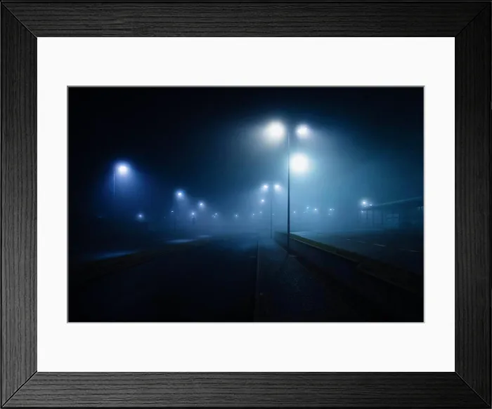 Framed Print : Street lamps illuminated over foggy, vacant road Framed Print : Street lamps illuminated over foggy, vacant road