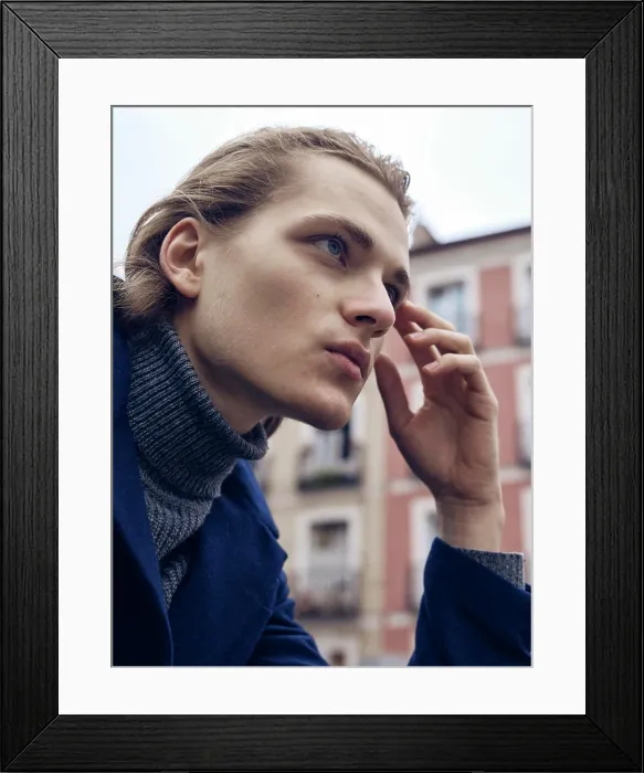 Framed Print : Side view of stylish young male with trendy hairstyle dressed in elegant coat standing in city