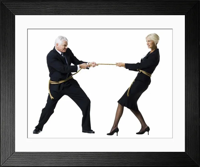 Framed Print : Businessman and businesswoman in a tug of war Framed Print : Businessman and businesswoman in a tug of war