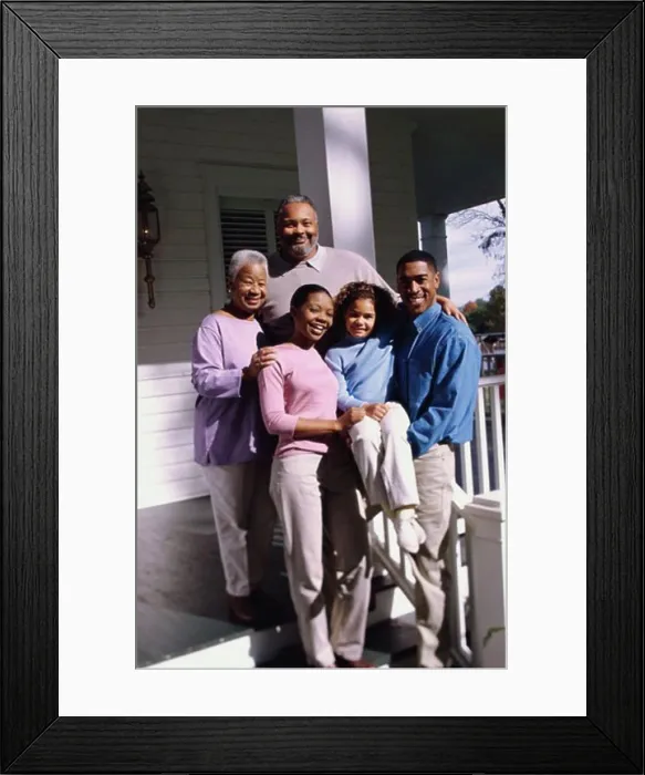 Framed Print : Family standing in front of a house Framed Print : Family standing in front of a house