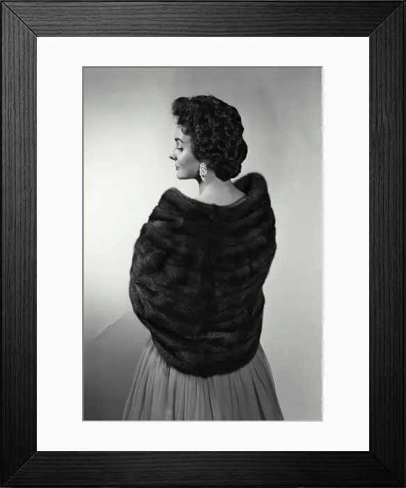 Framed Print : Rear view of a young woman wearing a fur shawl Framed Print : Rear view of a young woman wearing a fur shawl