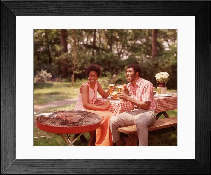 Framed Print : 1970s SMILING AFRICAN AMERICAN COUPLE MAN WOMAN DRINKING BEER AT BACKYARD BARBECUE
