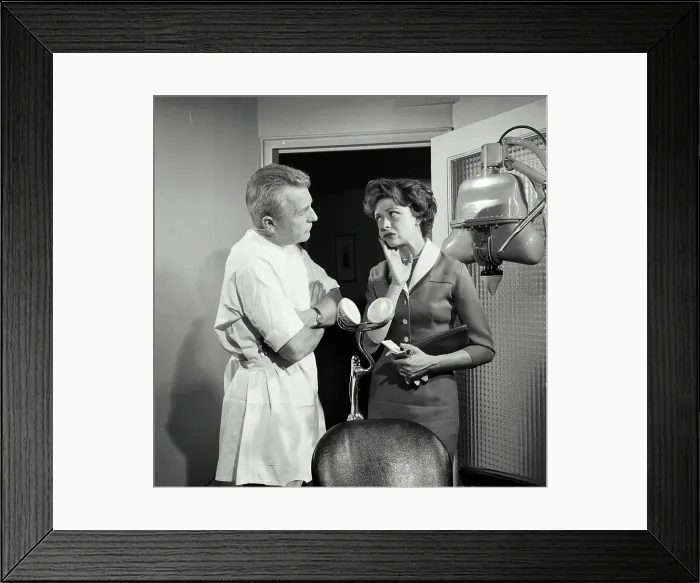 Framed Print : Female patient suffering from toothache standing with dentist Framed Print : Female patient suffering from toothache standing with dentist