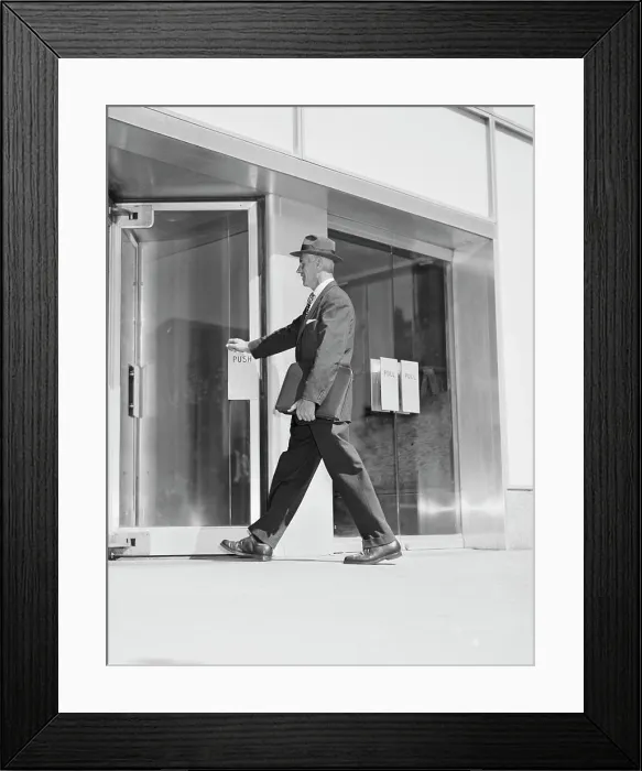 Framed Print : Senior businessman entering office building Framed Print : Senior businessman entering office building