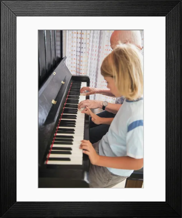 Framed Print : Grandfather and grandson playing piano instrument Framed Print : Grandfather and grandson playing piano instrument