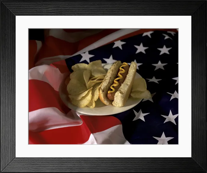 Framed Print : Hot dog with potato chips on an American flag Framed Print : Hot dog with potato chips on an American flag