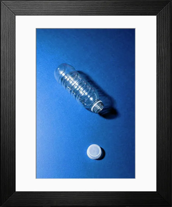 Framed Print : High angle view of empty plastic bottle on blue table Framed Print : High angle view of empty plastic bottle on blue table
