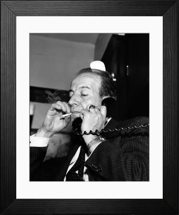 Framed Print : Man with cigarette talking on phone