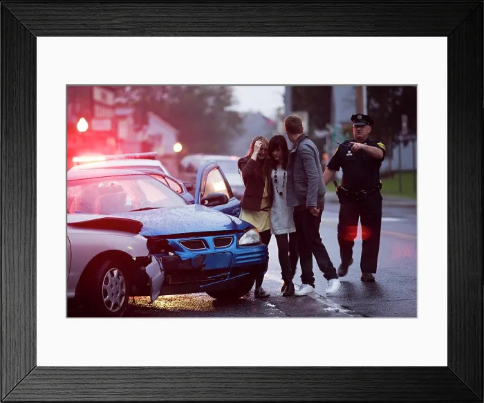 Framed Print : Police officer on scene of automobile accident escorting three injured young adults to safety Framed Print : Police officer on scene of automobile accident escorting three injured young adults to safety