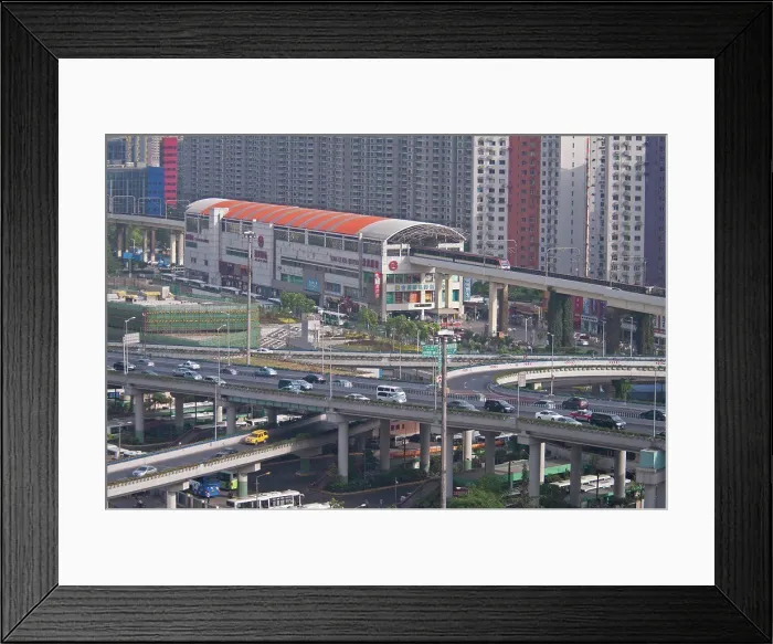 Framed Print : China, Shanghai, Light Railway train leaving Caoxi Road station in south Shanghai in the early morning with cars