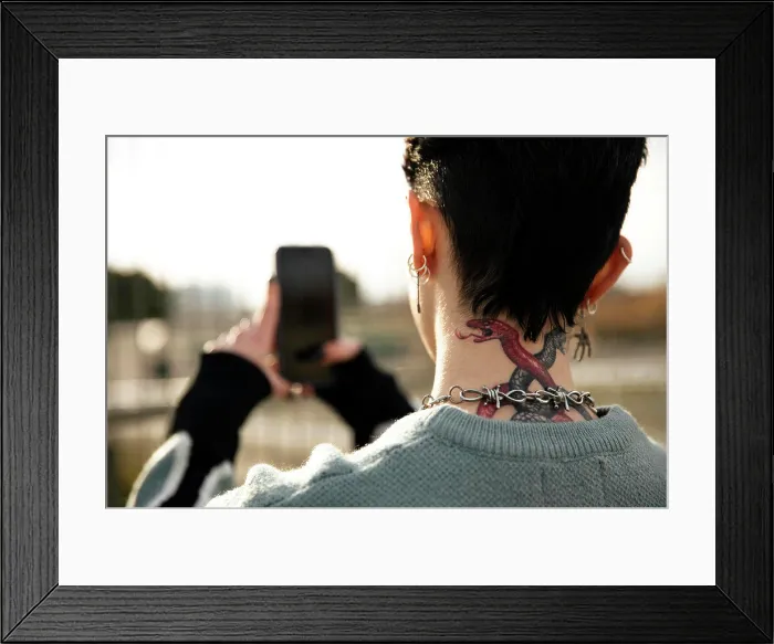 Framed Print : Unrecognizable girl with a tattoo taking a picture Framed Print : Unrecognizable girl with a tattoo taking a picture