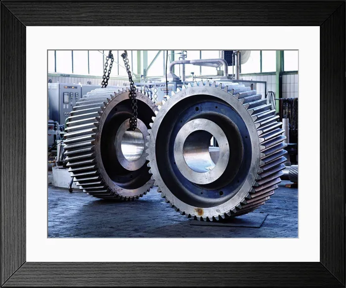 Framed Print : A pair of giant gear wheels in factory which produces gears