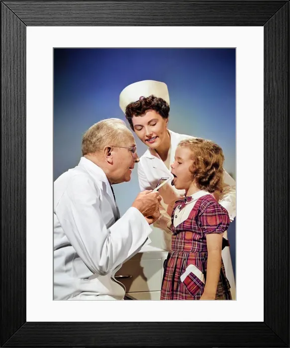 Framed Print : 1950s MAN DOCTOR EXAMINING MOUTH OF LITTLE GIRL CHILD WITH WOOD TONGUE DEPRESSOR WHILE WOMAN NURSE IS LOOKING ON Framed Print : 1950s MAN DOCTOR EXAMINING MOUTH OF LITTLE GIRL CHILD WITH WOOD TONGUE DEPRESSOR WHILE WOMAN NURSE IS LOOKING ON
