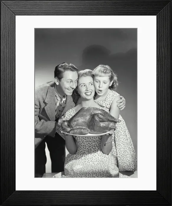Framed Print : Portrait of a family holding a turkey on a platter