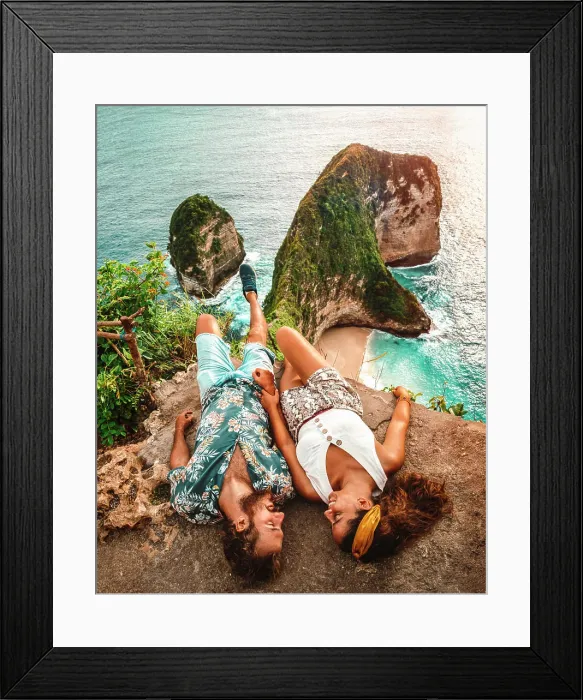 Framed Print : Carefree young couple on vacation in light casual wear lying down on peak of rough cliff Framed Print : Carefree young couple on vacation in light casual wear lying down on peak of rough cliff