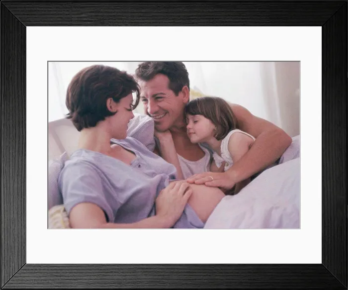 Framed Print : Pregnant woman with her husband and her daughter